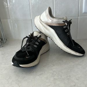 Black and white Nike Quests with gold